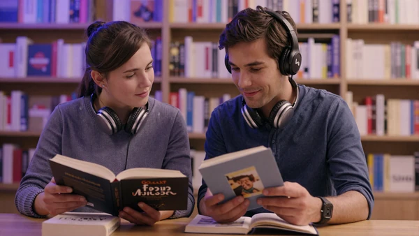 Autistic couple quietly browsing a bookstore together