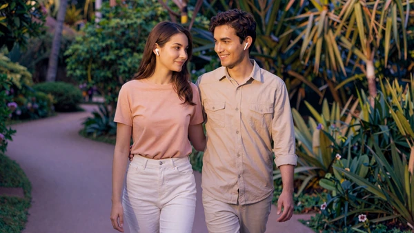 Neurodivergent couple walking a quiet botanical garden path at golden hour