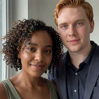 Maya and Jordan sitting close together in warm afternoon light