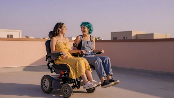 Interabled couple laughing together on a rooftop at golden hour